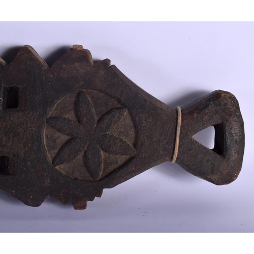 401 - AN UNUSUAL TRIBAL CARVED WOOD HANGING BOARD possibly a mancala board. 70 cm x 14 cm.