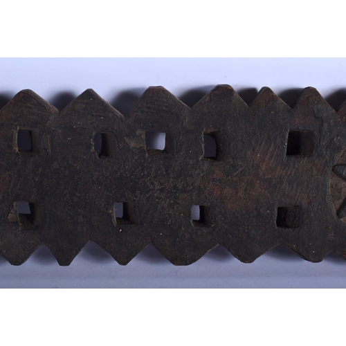 401 - AN UNUSUAL TRIBAL CARVED WOOD HANGING BOARD possibly a mancala board. 70 cm x 14 cm.