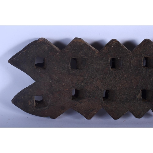 401 - AN UNUSUAL TRIBAL CARVED WOOD HANGING BOARD possibly a mancala board. 70 cm x 14 cm.