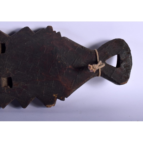 401 - AN UNUSUAL TRIBAL CARVED WOOD HANGING BOARD possibly a mancala board. 70 cm x 14 cm.