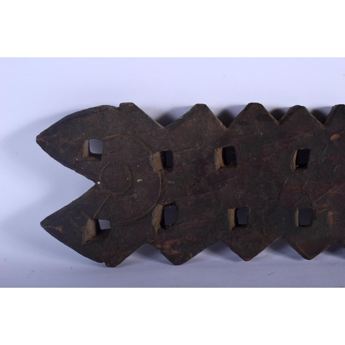 401 - AN UNUSUAL TRIBAL CARVED WOOD HANGING BOARD possibly a mancala board. 70 cm x 14 cm.