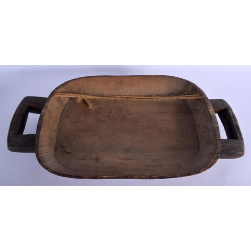 402 - AN AFRICAN TRIBAL CARVED TWIN HANDLED FOOD SERVING BOWL with chip carved backing. 62 cm x 28 cm.