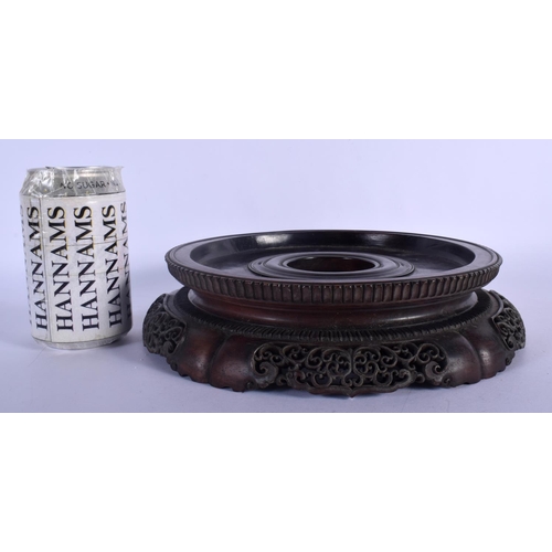 408 - A LARGE 19TH CENTURY CHINESE CARVED HARDWOOD CIRCULAR STAND Qing, with finely carved openwork frieze... 