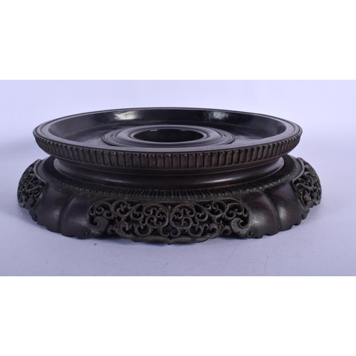 408 - A LARGE 19TH CENTURY CHINESE CARVED HARDWOOD CIRCULAR STAND Qing, with finely carved openwork frieze... 