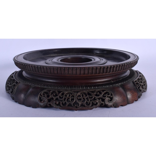 408 - A LARGE 19TH CENTURY CHINESE CARVED HARDWOOD CIRCULAR STAND Qing, with finely carved openwork frieze... 