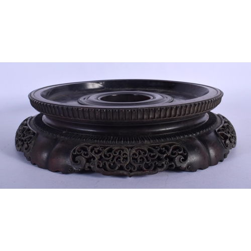 408 - A LARGE 19TH CENTURY CHINESE CARVED HARDWOOD CIRCULAR STAND Qing, with finely carved openwork frieze... 