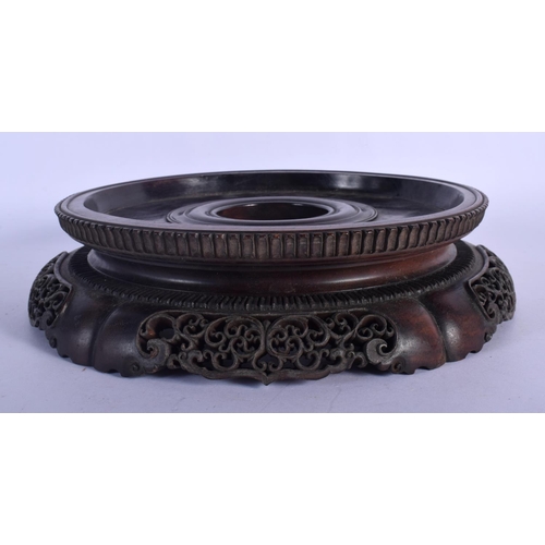 408 - A LARGE 19TH CENTURY CHINESE CARVED HARDWOOD CIRCULAR STAND Qing, with finely carved openwork frieze... 