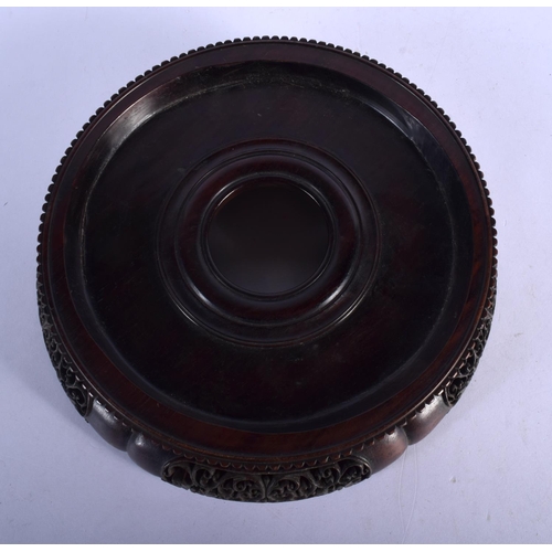 408 - A LARGE 19TH CENTURY CHINESE CARVED HARDWOOD CIRCULAR STAND Qing, with finely carved openwork frieze... 
