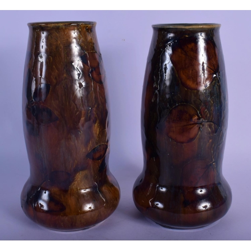 44 - A PAIR OF ROYAL DOULTON STONEWARE VASES painted with leaves. 20 cm high.