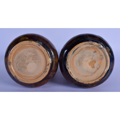 44 - A PAIR OF ROYAL DOULTON STONEWARE VASES painted with leaves. 20 cm high.