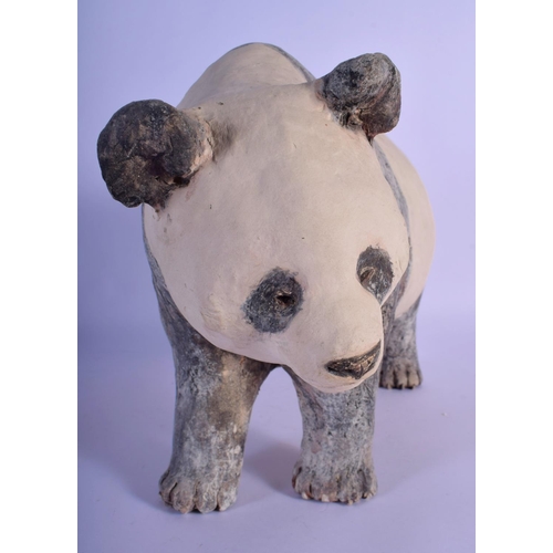 48 - A CONTEMPORARY PAINTED POTTERY MODEL OF A PANDA modelled roaming. 35 cm x 25 cm.