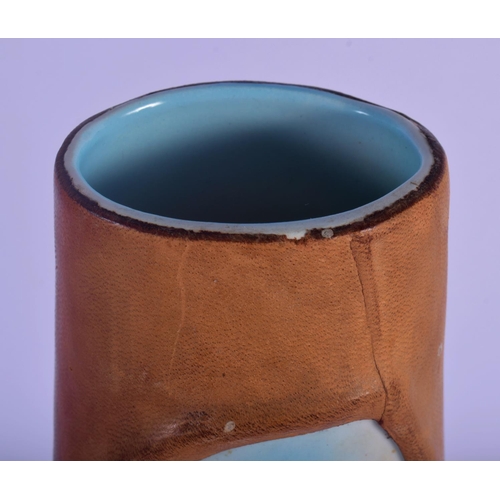 52 - A RETRO ITALIAN LEATHER AND PORCELAIN VASE. 33 cm high.