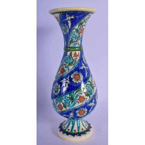 54 - A MIDDLE EASTERN PERSIAN IZNIK FAIENCE VASE. 25 cm high.