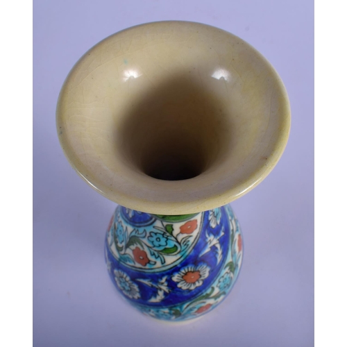54 - A MIDDLE EASTERN PERSIAN IZNIK FAIENCE VASE. 25 cm high.
