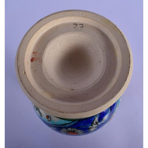54 - A MIDDLE EASTERN PERSIAN IZNIK FAIENCE VASE. 25 cm high.