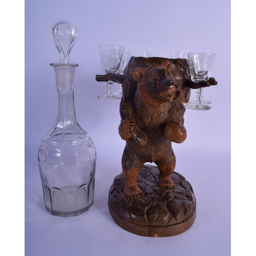 55 - A 19TH CENTURY BAVARIAN BLACK FOREST CARVED WOOD LIQUOR SET with glasses and decanter. Bear 27 cm x ... 