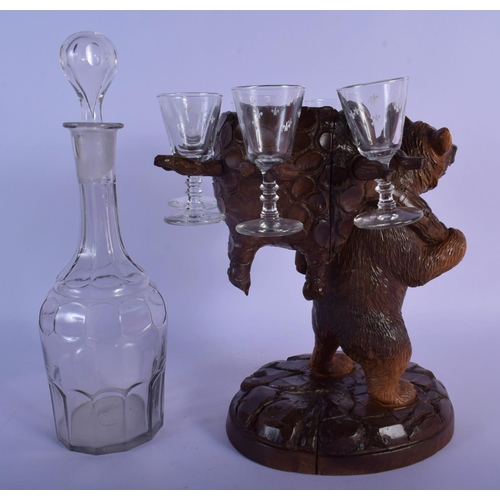 55 - A 19TH CENTURY BAVARIAN BLACK FOREST CARVED WOOD LIQUOR SET with glasses and decanter. Bear 27 cm x ... 