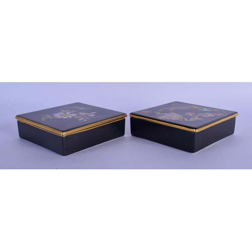 59 - A PAIR OF CARLTONWARE BLACK GROUND PORCELAIN BOXES AND COVERS painted with birds and flowers. 11.5 c... 