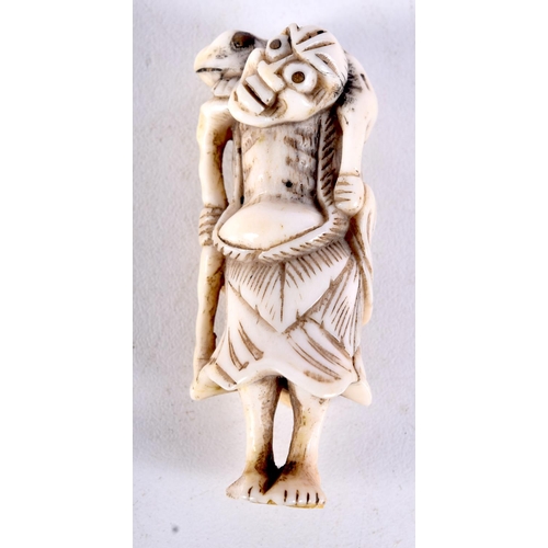 25 - A 19TH CENTURY JAPANESE MEIJI PERIOD CARVED IVORY NETSUKE modelled as a male holding a toad. 6 cm hi... 
