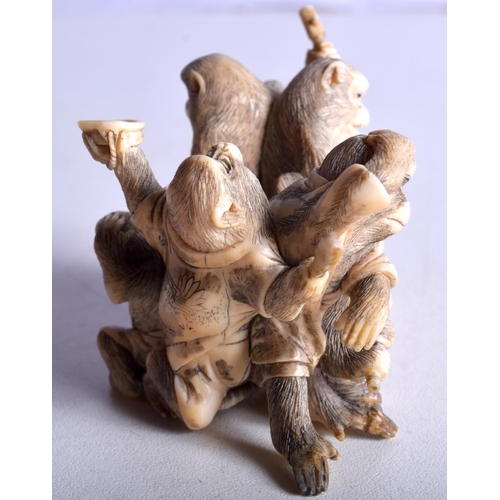 28 - A 19TH CENTURY JAPANESE MEIJI PERIOD CARVED IVORY OKIMONO modelled as numerous monkeys. 7 cm x 5 cm.