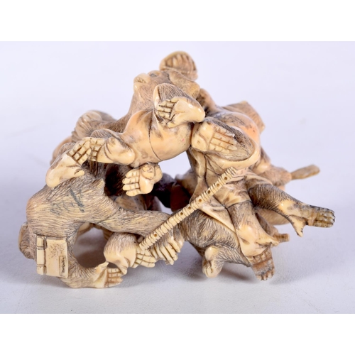 28 - A 19TH CENTURY JAPANESE MEIJI PERIOD CARVED IVORY OKIMONO modelled as numerous monkeys. 7 cm x 5 cm.