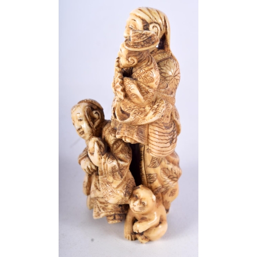 29 - A 19TH CENTURY JAPANESE MEIJI PERIOD CARVED IVORY OKIMONO modelled as a male with two other figures.... 