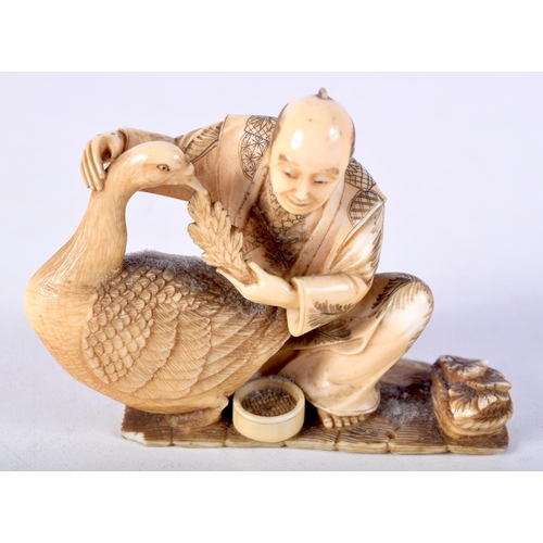 4 - A 19TH CENTURY JAPANESE MEIJI PERIOD CARVED IVORY OKIMONO modelled as a male holding a bird. 8.5 cm ... 