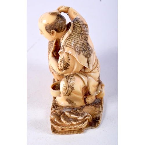 4 - A 19TH CENTURY JAPANESE MEIJI PERIOD CARVED IVORY OKIMONO modelled as a male holding a bird. 8.5 cm ... 
