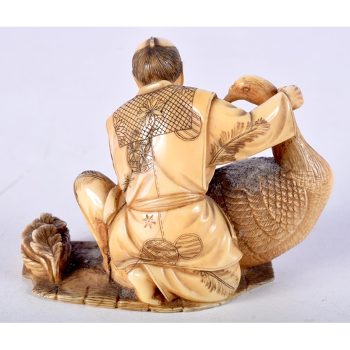 4 - A 19TH CENTURY JAPANESE MEIJI PERIOD CARVED IVORY OKIMONO modelled as a male holding a bird. 8.5 cm ... 