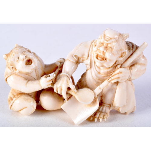 41 - A 19TH CENTURY JAPANESE MEIJI PERIOD CARVED IVORY OKIMONO modelled as two devilish figures. 8 cm x 4... 