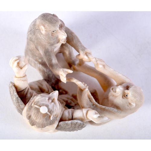 44 - A 19TH CENTURY JAPANESE MEIJI PERIOD CARVED IVORY OKIMONO modelled as monkeys and birds. 6.5 cm x 4 ... 