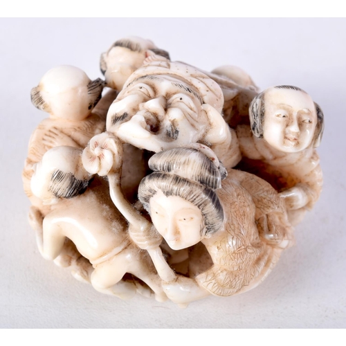 47 - A 19TH CENTURY JAPANESE MEIJI PERIOD CARVED IVORY OKIMONO modelled as numerous figures holding masks... 