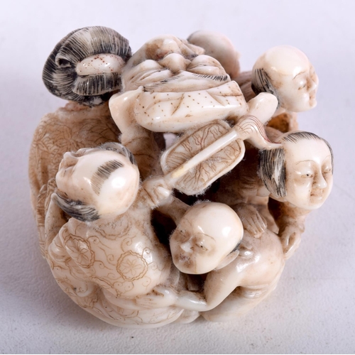 47 - A 19TH CENTURY JAPANESE MEIJI PERIOD CARVED IVORY OKIMONO modelled as numerous figures holding masks... 