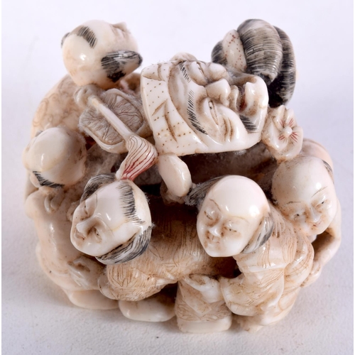 47 - A 19TH CENTURY JAPANESE MEIJI PERIOD CARVED IVORY OKIMONO modelled as numerous figures holding masks... 