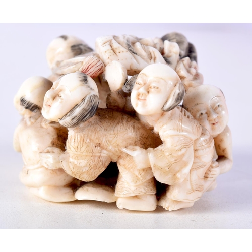 47 - A 19TH CENTURY JAPANESE MEIJI PERIOD CARVED IVORY OKIMONO modelled as numerous figures holding masks... 