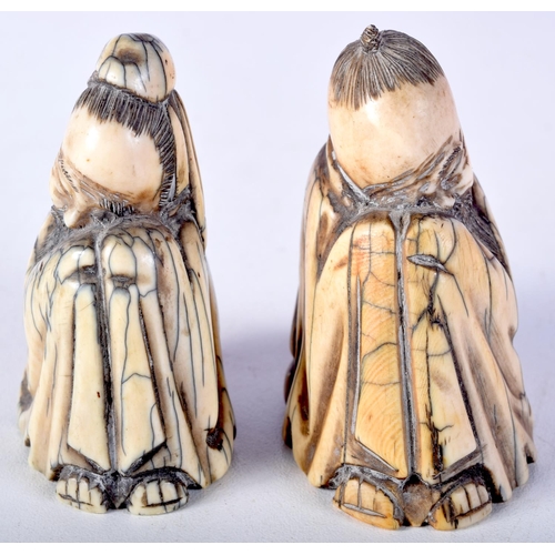 50 - A PAIR OF 19TH CENTURY CHINESE CARVED MAMMOTH IVORY FIGURES OF SCHOLARS modelled in robes. 7 cm x 4.... 