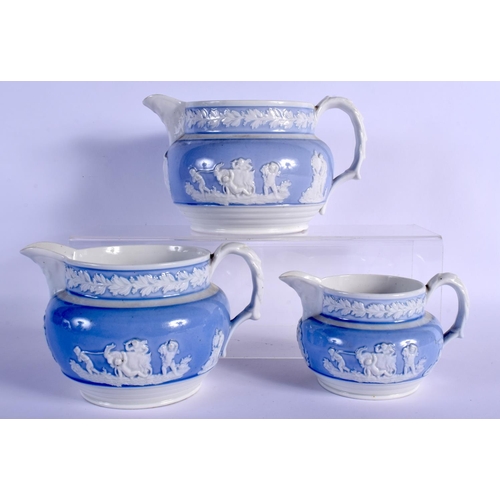 156 - THREE GRADUATED ENGLISH PORCELAIN JUGS WITH LIGHT BLUE GROUND RELIEF MOULDED WITH COUNTRY SCENES 11.... 