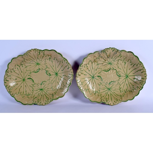 18 - A PAIR OF 19TH CENTURY WEDGWOOD LEAF MOULDED DISHES painted with green sprays. 26 cm x 21 cm.