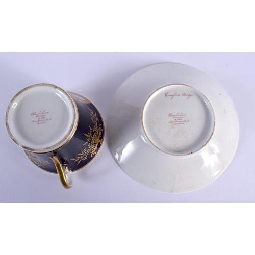194 - CHAMBERLAIN~S WORCESTER LARGE CUP AND STAND PAINTED WITH CRANFORD BRIDGE IN A GILT PANEL ON A COBALT... 