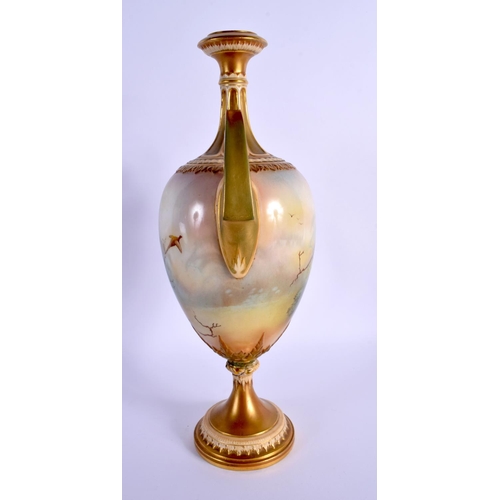 219 - A LARGE ROYAL WORCESTER TWIN HANDLED PORCELAIN VASE by Lewis, painted with game birds within landsca... 