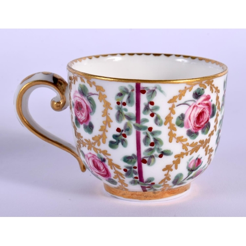 23 - A SMALL 19TH CENTURY FRENCH SEVRES PORCELAIN CUP AND SAUCER painted with roses. 8.5 cm wide.