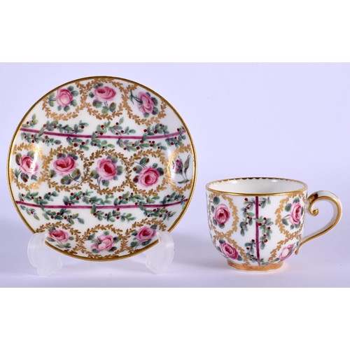 23 - A SMALL 19TH CENTURY FRENCH SEVRES PORCELAIN CUP AND SAUCER painted with roses. 8.5 cm wide.