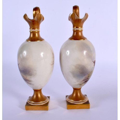 236 - A PAIR OF ROYAL WORCESTER PORCELAIN EWERS by Harry Stinton, painted with highland cattle. 17 cm high... 