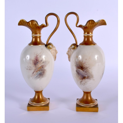 236 - A PAIR OF ROYAL WORCESTER PORCELAIN EWERS by Harry Stinton, painted with highland cattle. 17 cm high... 