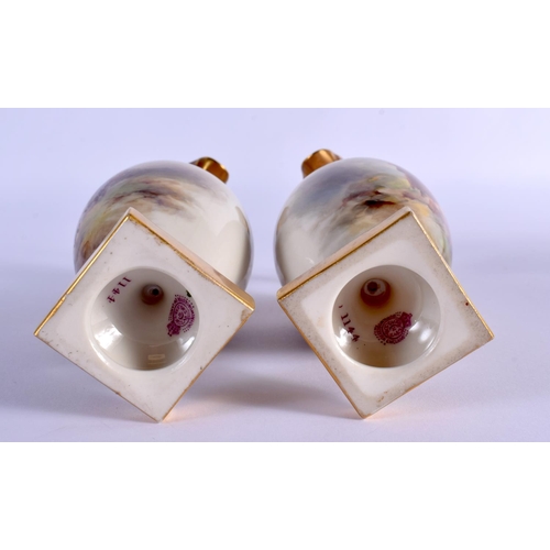 236 - A PAIR OF ROYAL WORCESTER PORCELAIN EWERS by Harry Stinton, painted with highland cattle. 17 cm high... 
