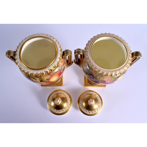 249 - A FINE PAIR OF TWIN HANDLED ROYAL WORCESTER VASES AND COVERS by Freeman, painted with fruit and berr... 