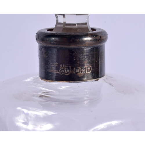 257 - AN ANTIQUE SILVER MOUNTED GLASS DECANTER. 19 cm high.