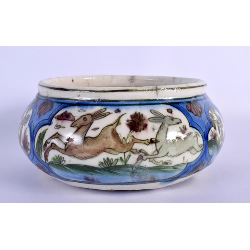 262 - A 19TH CENTURY ISLAMIC MIDDLE EASTERN QAJAR POTTERY BOWL painted with deer. 15 cm wide.