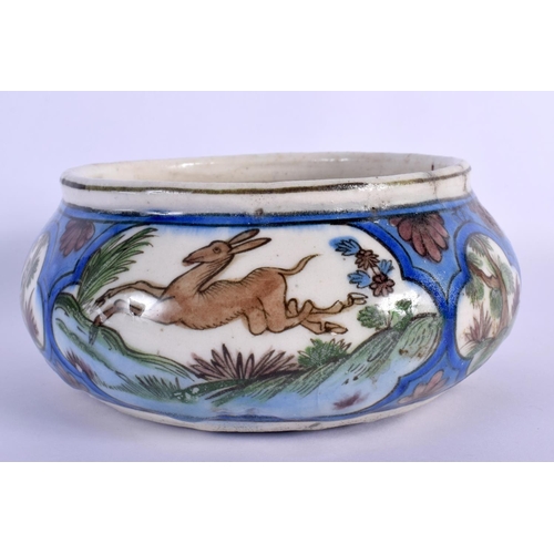 262 - A 19TH CENTURY ISLAMIC MIDDLE EASTERN QAJAR POTTERY BOWL painted with deer. 15 cm wide.