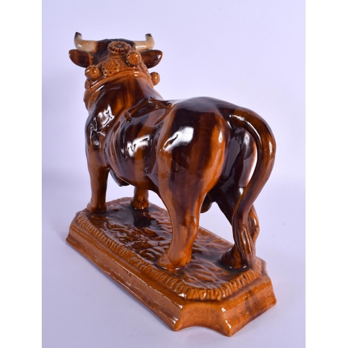 265 - A LARGE 19TH CENTURY EUROPEAN TREACLE GLAZED BULL DECANTER AND STOPPER. 25 cm x 18 cm.